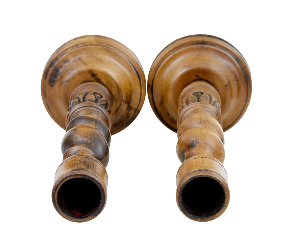 A pair of early 20th-century turned wood candlesticks featuring spiral stems, carved leaf accents, and wide circular bases. View IV