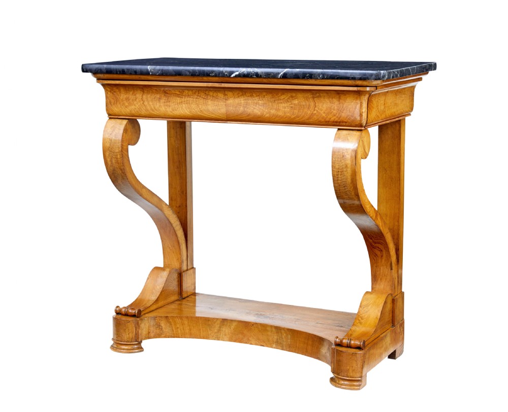 A mid-19th century Swedish console table made from light-coloured elm wood with a black marble top and curved s-scroll legs.
