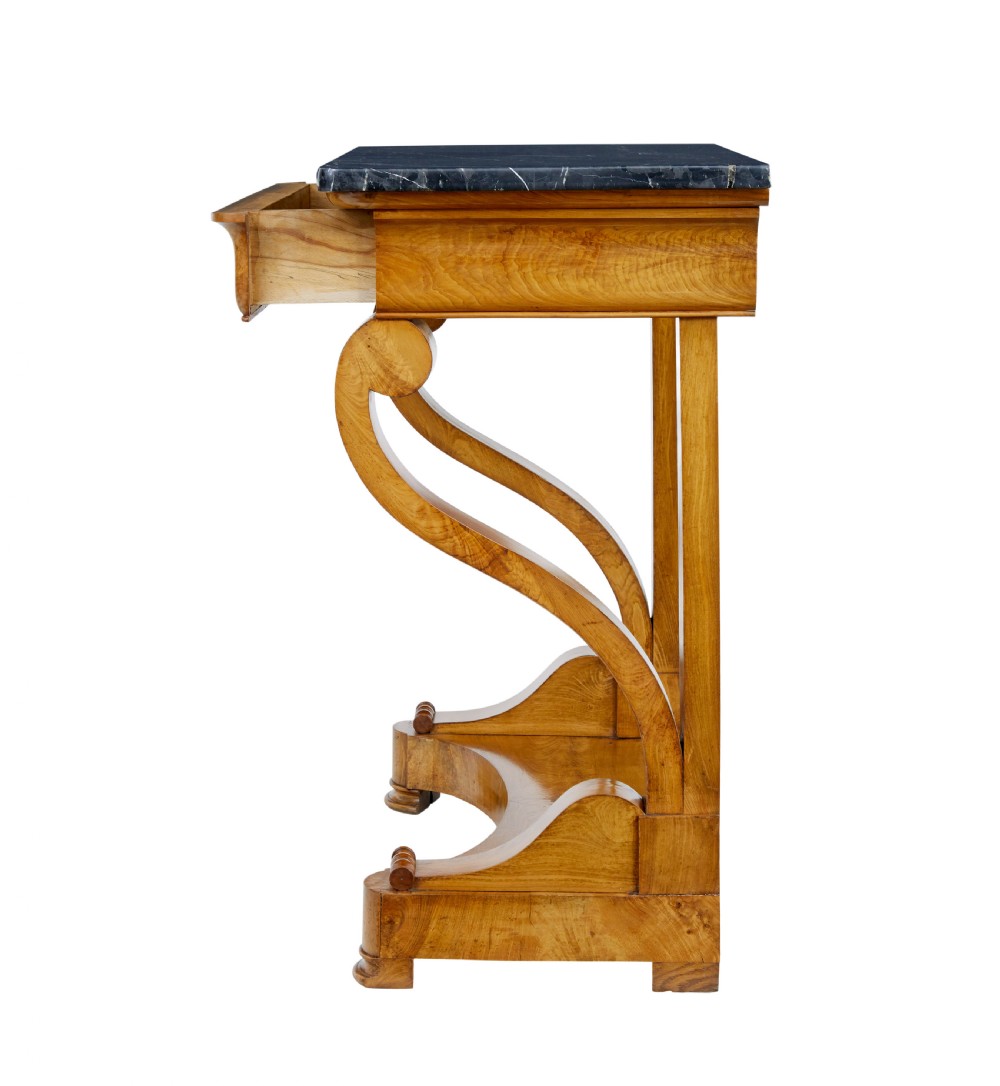 A mid-19th century Swedish console table made from light-coloured elm wood with a black marble top and curved s-scroll legs. View V