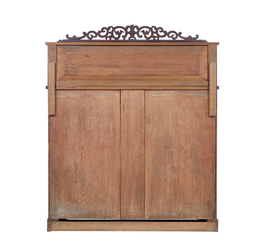A nineteenth-century Regency palisander chiffonier sideboard with its two panelled doors open, revealing internal wooden shelves, topped with a carved scrollwork gallery shelf. View IV