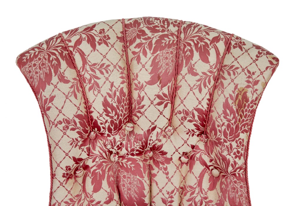 An early 20th century three-piece upholstered salon suite featuring a two-seater settee and two matching armchairs with pink and cream floral damask pattern, button-tufted fluted backs, and turned wooden legs with brass castors. View VIII