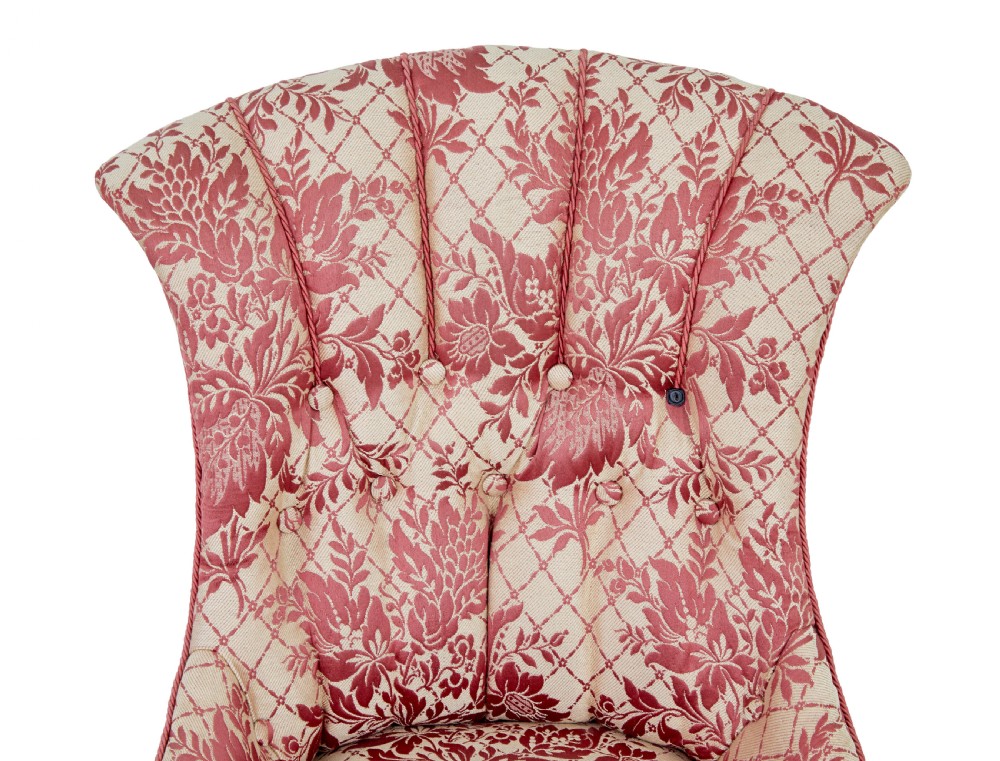 An early 20th century three-piece upholstered salon suite featuring a two-seater settee and two matching armchairs with pink and cream floral damask pattern, button-tufted fluted backs, and turned wooden legs with brass castors. View XI