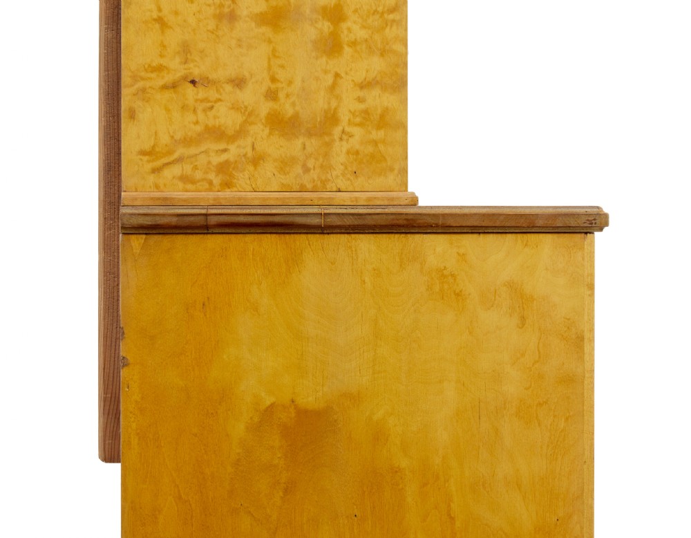 A late 19th-century Swedish satin birch cabinet featuring a three-door glazed top section with curved glazing bars resting on a five-drawer chest with dark faceted knobs. View VII