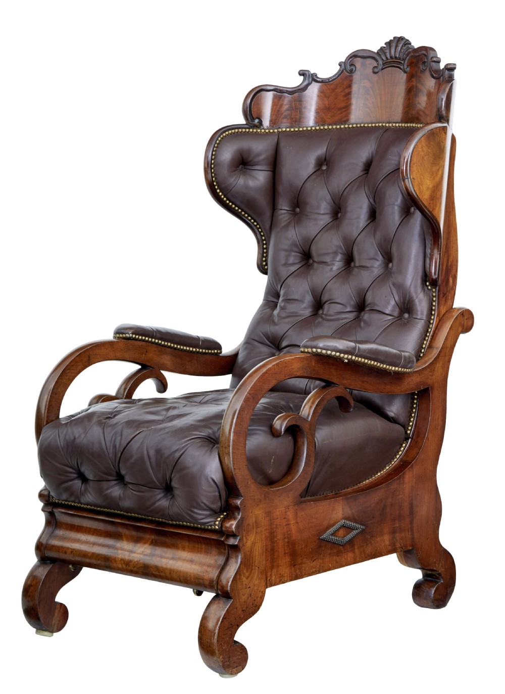 A mid-19th-century French reclining armchair featuring carved mahogany scrolled arms, a cresting motif, and deep-buttoned dark brown leather upholstery trimmed with brass studs.