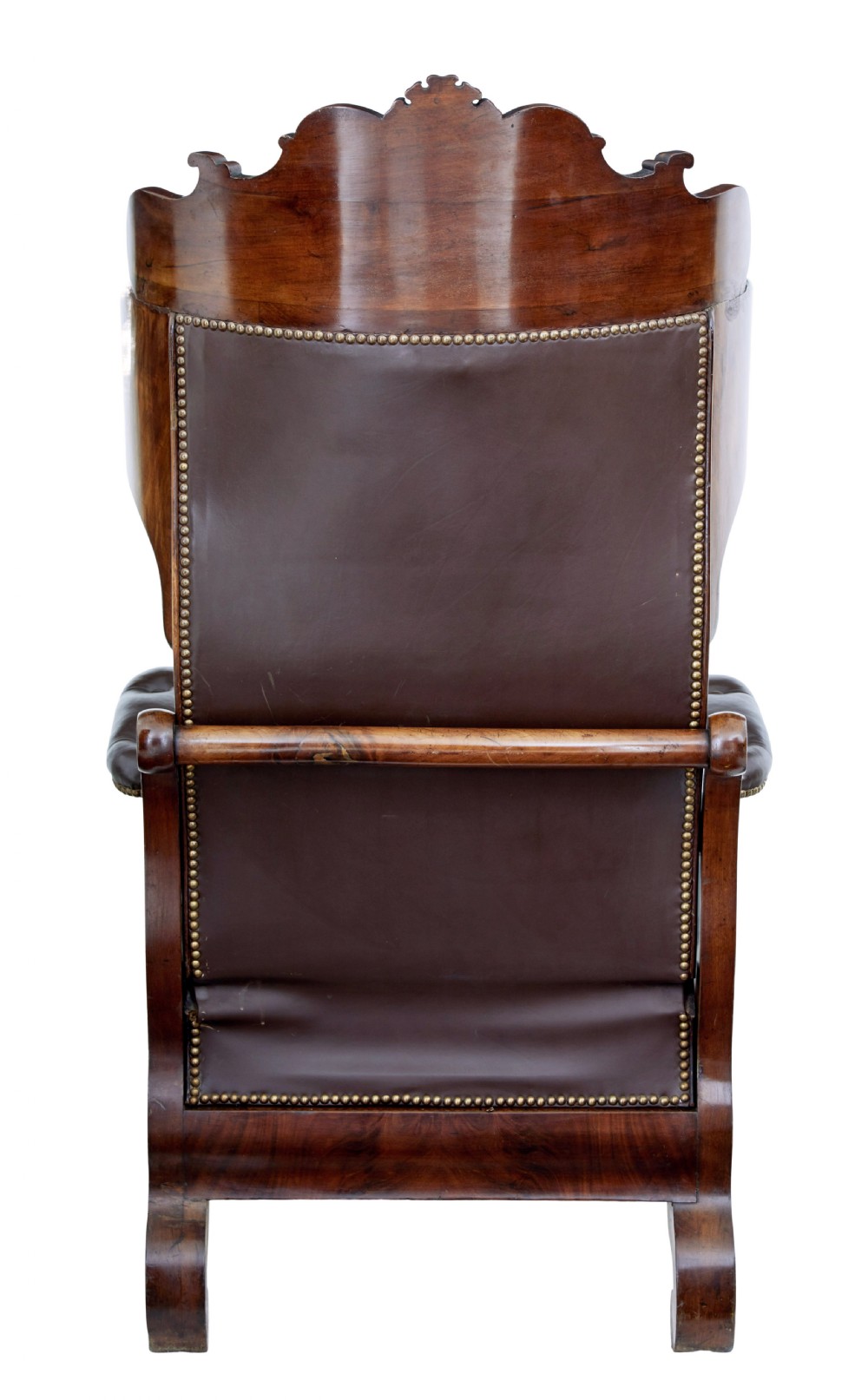 A mid-19th-century French reclining armchair featuring carved mahogany scrolled arms, a cresting motif, and deep-buttoned dark brown leather upholstery trimmed with brass studs. View III
