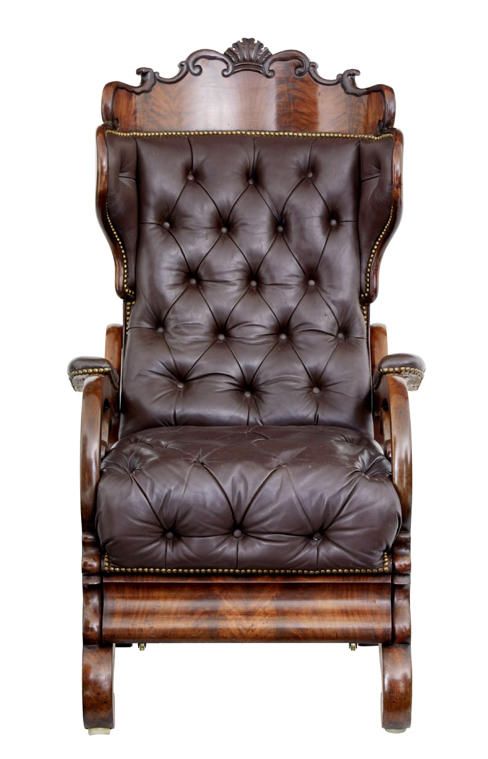 A mid-19th-century French reclining armchair featuring carved mahogany scrolled arms, a cresting motif, and deep-buttoned dark brown leather upholstery trimmed with brass studs. View V