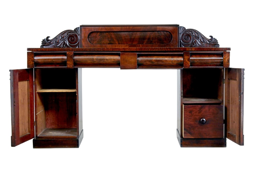 A nineteenth-century William IV mahogany pedestal sideboard featuring an architectural splashback with carved scrolls, frieze section, and two cupboard pedestals on plinth bases. View II