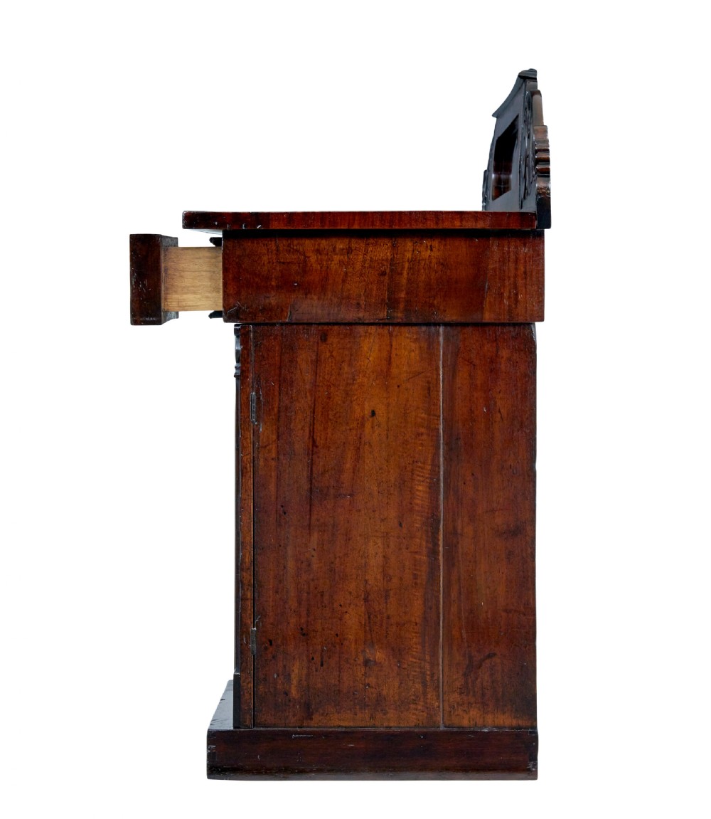 A nineteenth-century William IV mahogany pedestal sideboard featuring an architectural splashback with carved scrolls, frieze section, and two cupboard pedestals on plinth bases. View III