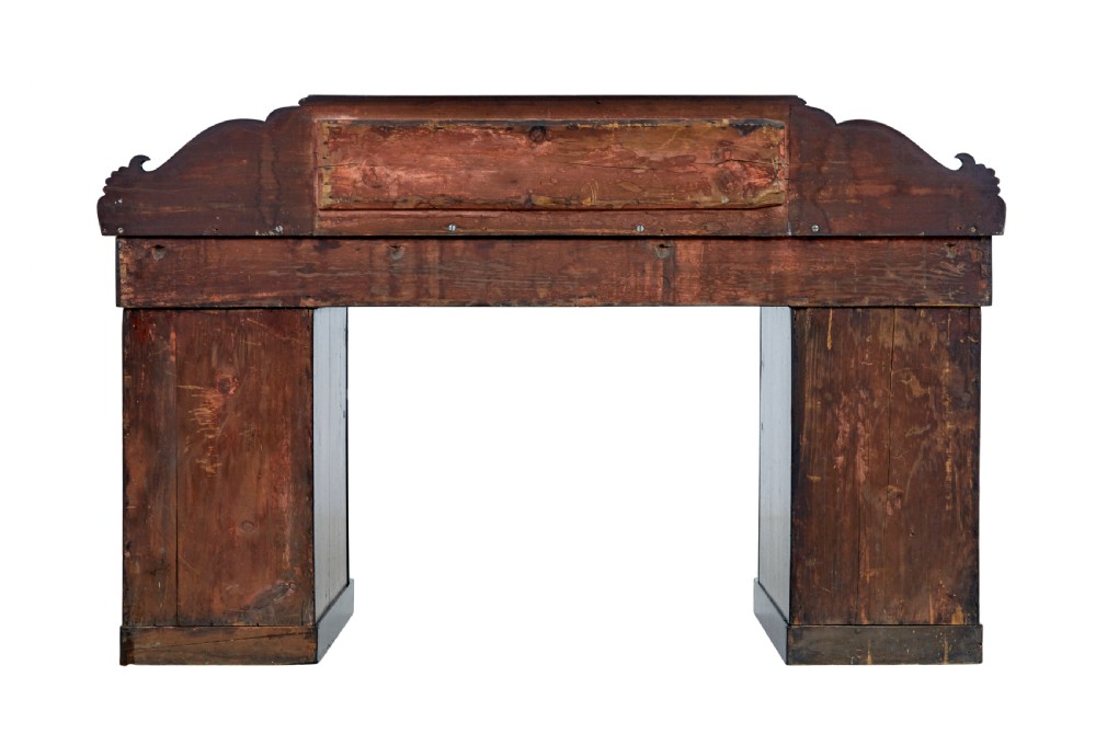 A nineteenth-century William IV mahogany pedestal sideboard featuring an architectural splashback with carved scrolls, frieze section, and two cupboard pedestals on plinth bases. View IV