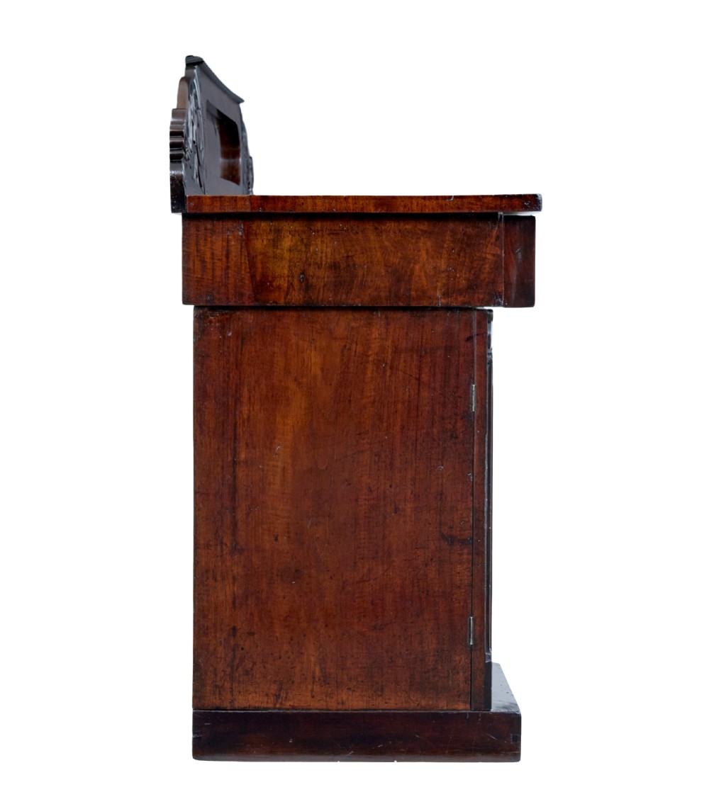 A nineteenth-century William IV mahogany pedestal sideboard featuring an architectural splashback with carved scrolls, frieze section, and two cupboard pedestals on plinth bases. View V