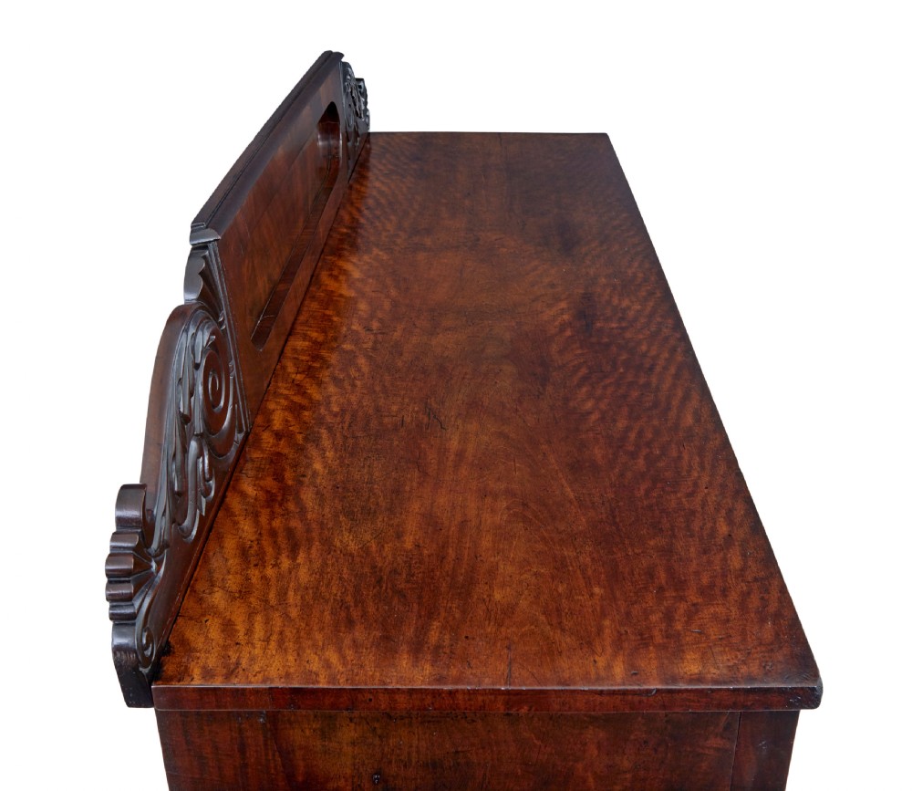 A nineteenth-century William IV mahogany pedestal sideboard featuring an architectural splashback with carved scrolls, frieze section, and two cupboard pedestals on plinth bases. View VI