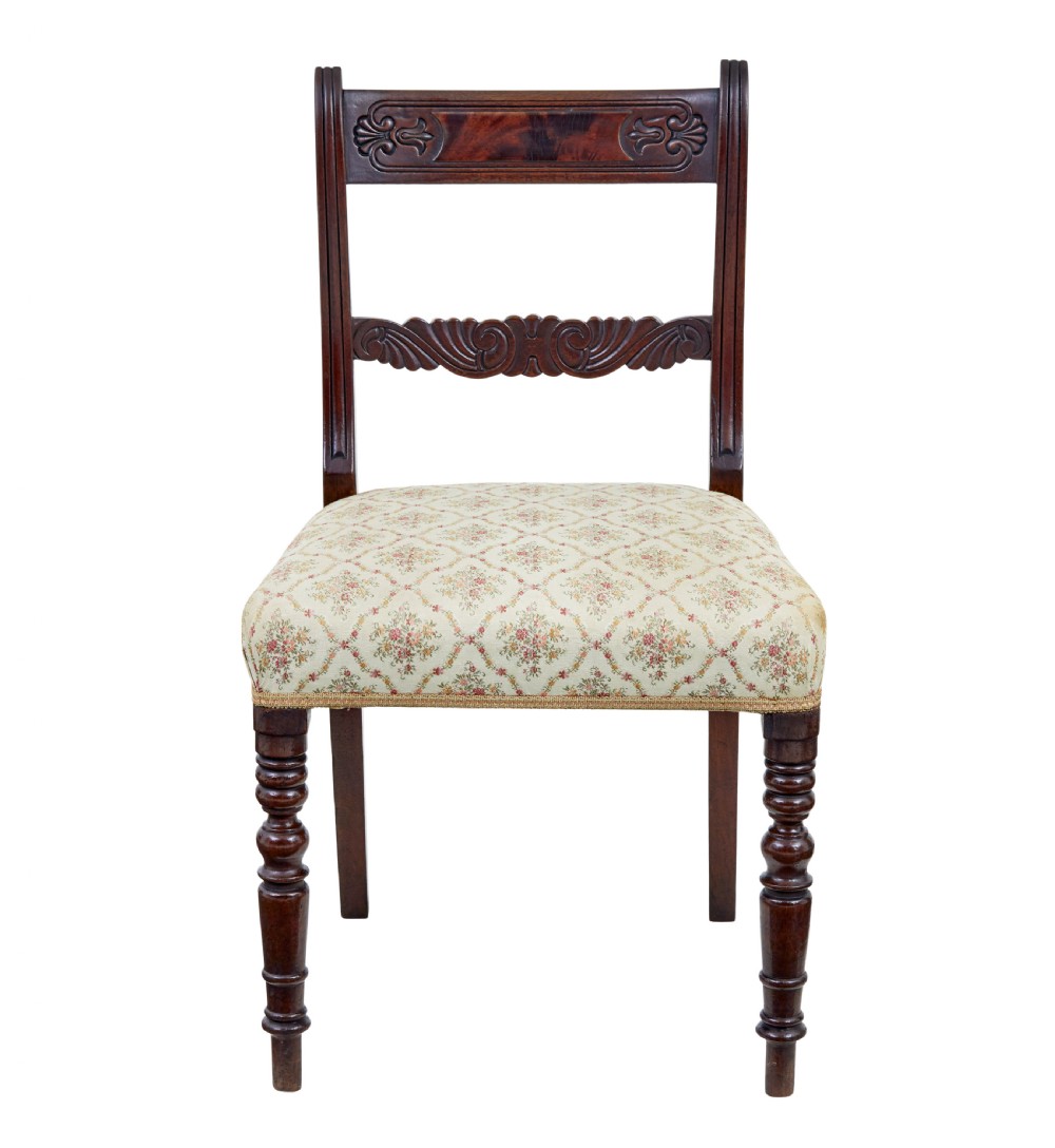 A set of six 19th-century Regency mahogany dining chairs with carved crest rails, turned front legs, and patterned upholstered seats. View II
