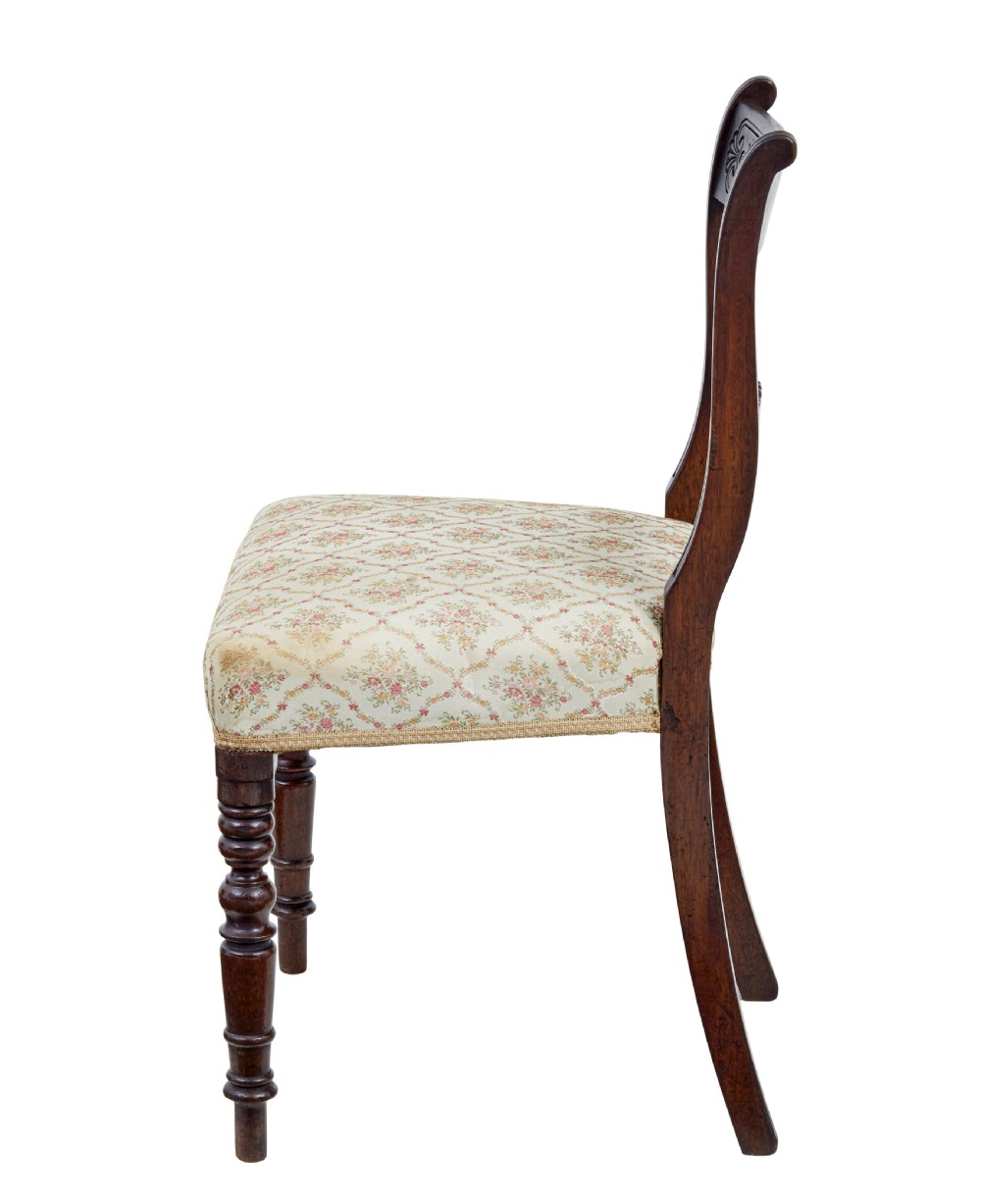 A set of six 19th-century Regency mahogany dining chairs with carved crest rails, turned front legs, and patterned upholstered seats. View III