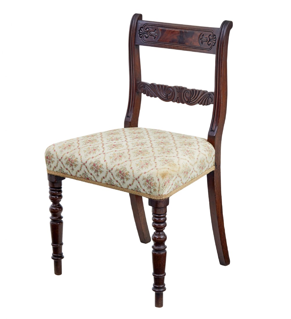 A set of six 19th-century Regency mahogany dining chairs with carved crest rails, turned front legs, and patterned upholstered seats. View IV