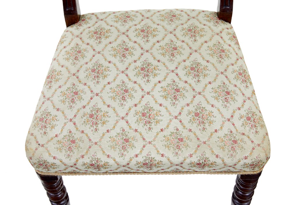 A set of six 19th-century Regency mahogany dining chairs with carved crest rails, turned front legs, and patterned upholstered seats. View VIII