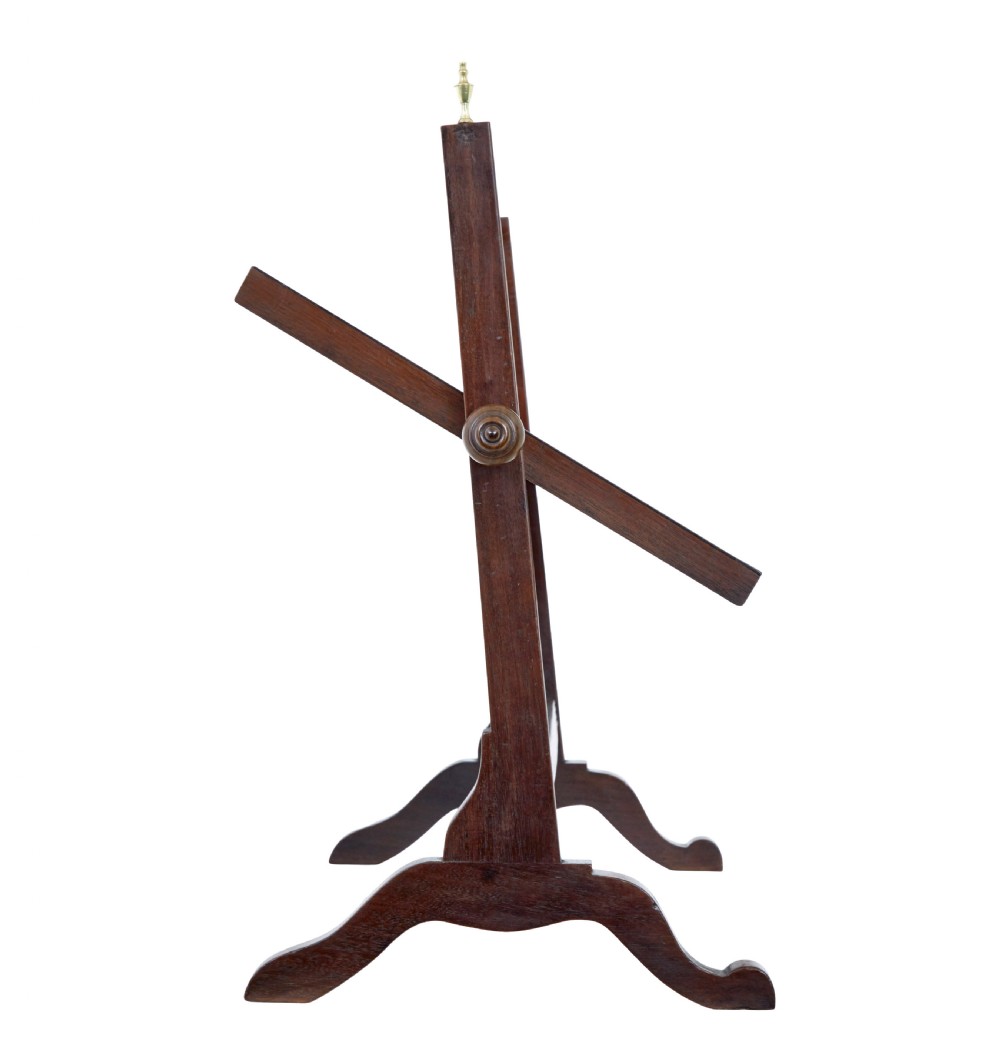 A 19th-century dark mahogany toilet mirror with a rectangular swivelling frame, reeded vertical uprights topped with brass finials, and splayed legs. View IV