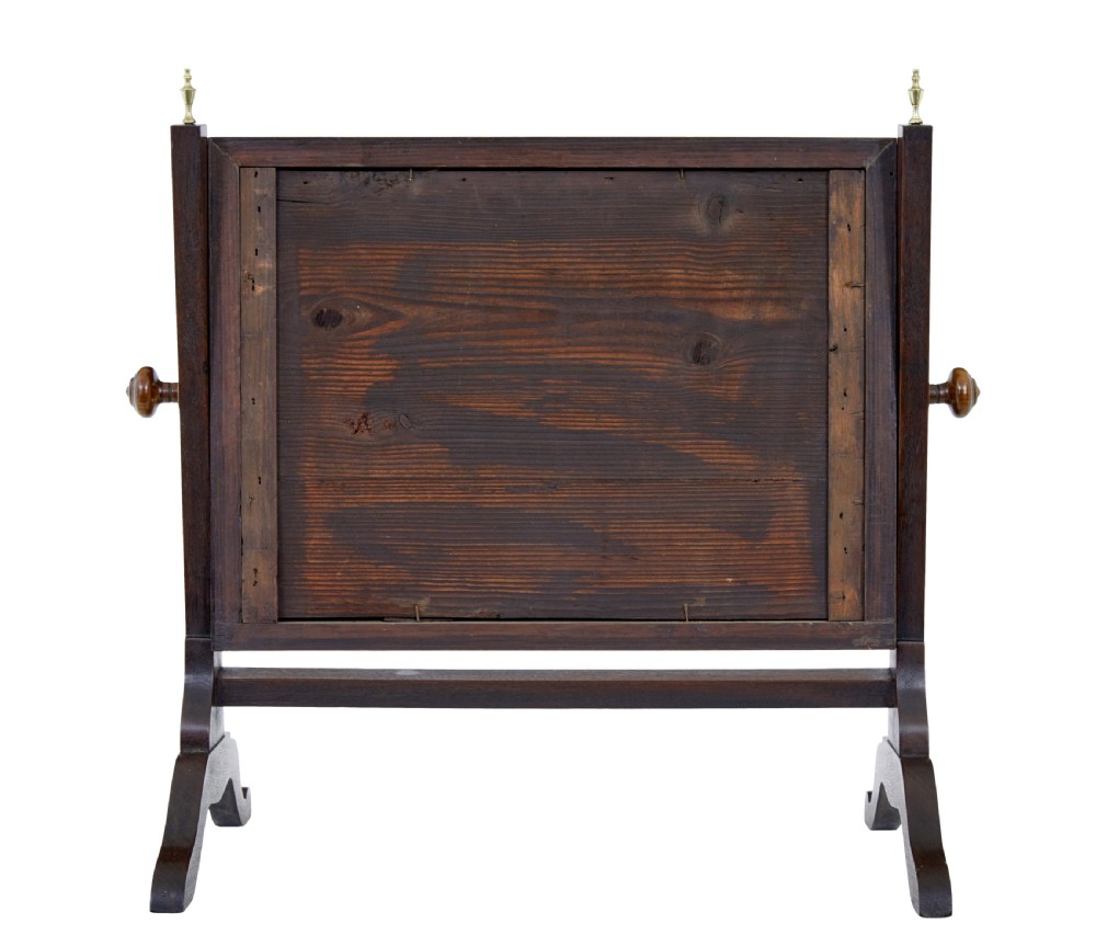 A 19th-century dark mahogany toilet mirror with a rectangular swivelling frame, reeded vertical uprights topped with brass finials, and splayed legs. View V