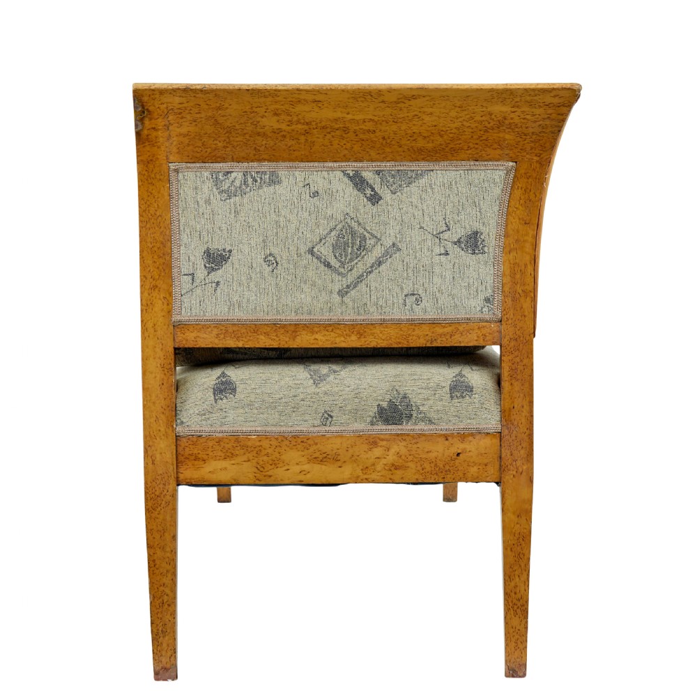 A seven-piece late nineteenth-century seating suite crafted from burr birch timber, including a high-backed sofa and six matching slat-back chairs with patterned fabric seats. View VI