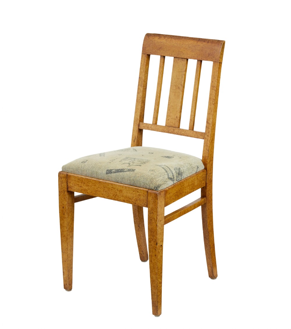 A seven-piece late nineteenth-century seating suite crafted from burr birch timber, including a high-backed sofa and six matching slat-back chairs with patterned fabric seats. View X
