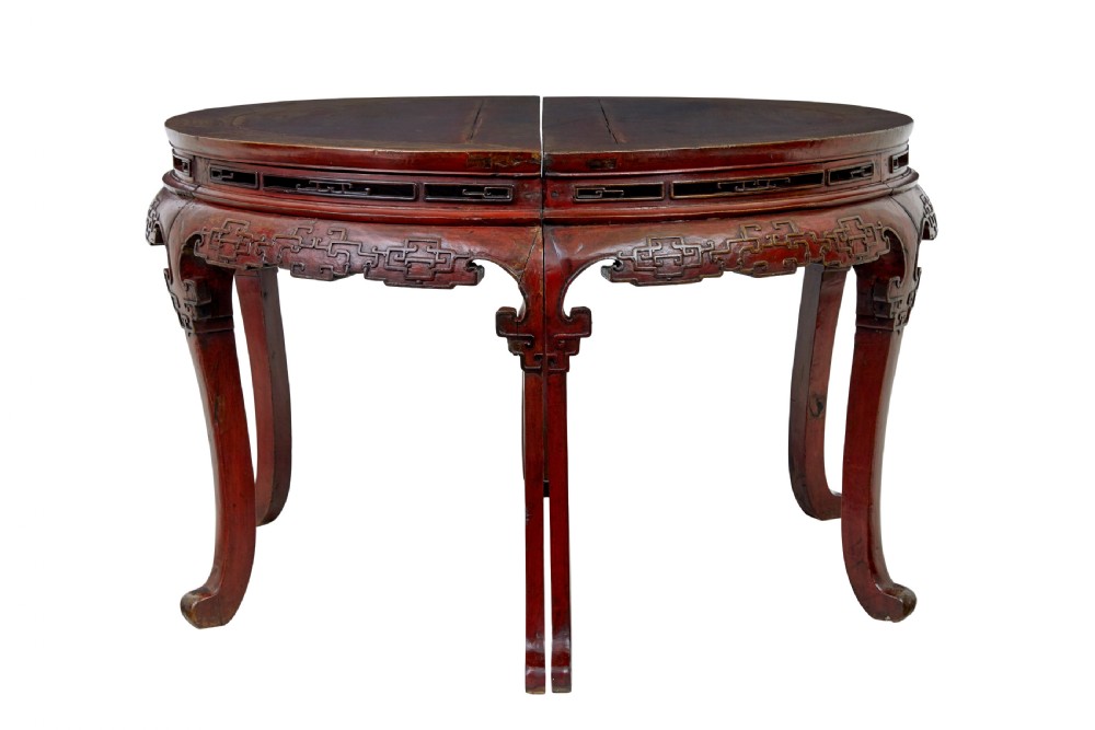 A pair of 19th-century Chinese red lacquer demi-lune tables joined together to form a circular table with carved key-fret aprons and cabriole legs. View II