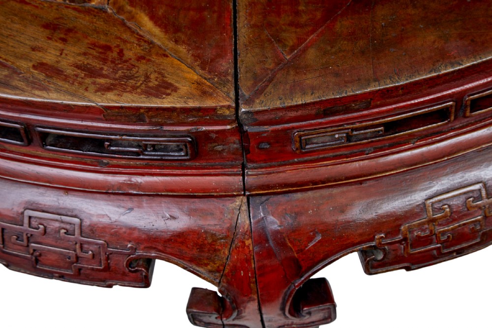 A pair of 19th-century Chinese red lacquer demi-lune tables joined together to form a circular table with carved key-fret aprons and cabriole legs. View VI