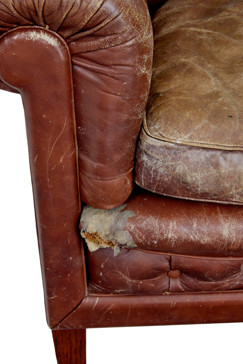 A pair of early 20th-century brown leather club armchairs with deep buttoning, rolled arms, loose seat cushions, and square timber legs. View VIII