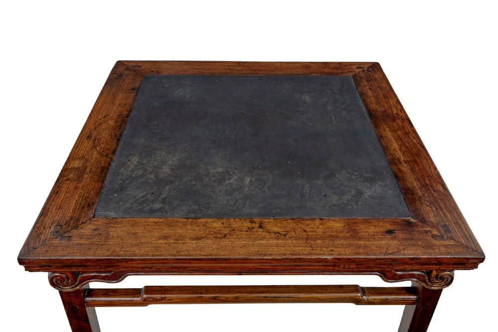 A 19th-century square Chinese hardwood centre table with an inset dark marble top, carved scroll spandrels, and humpback stretchers. View II
