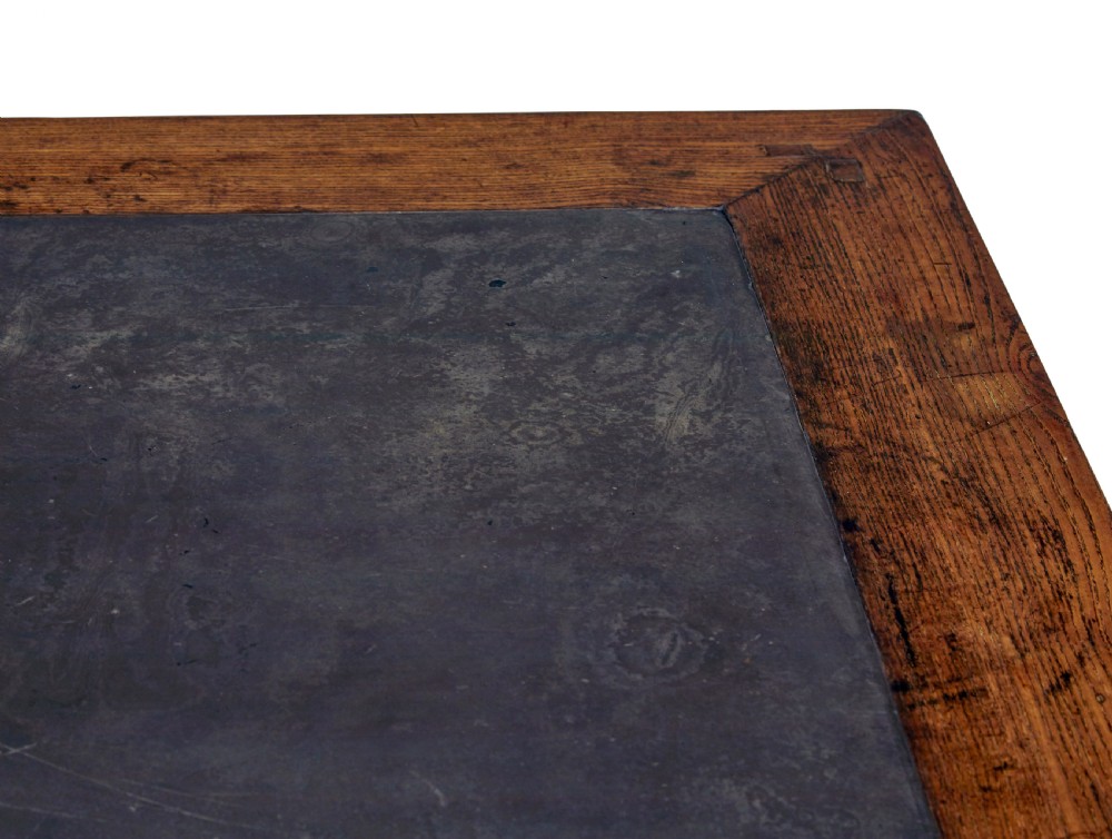 A 19th-century square Chinese hardwood centre table with an inset dark marble top, carved scroll spandrels, and humpback stretchers. View V