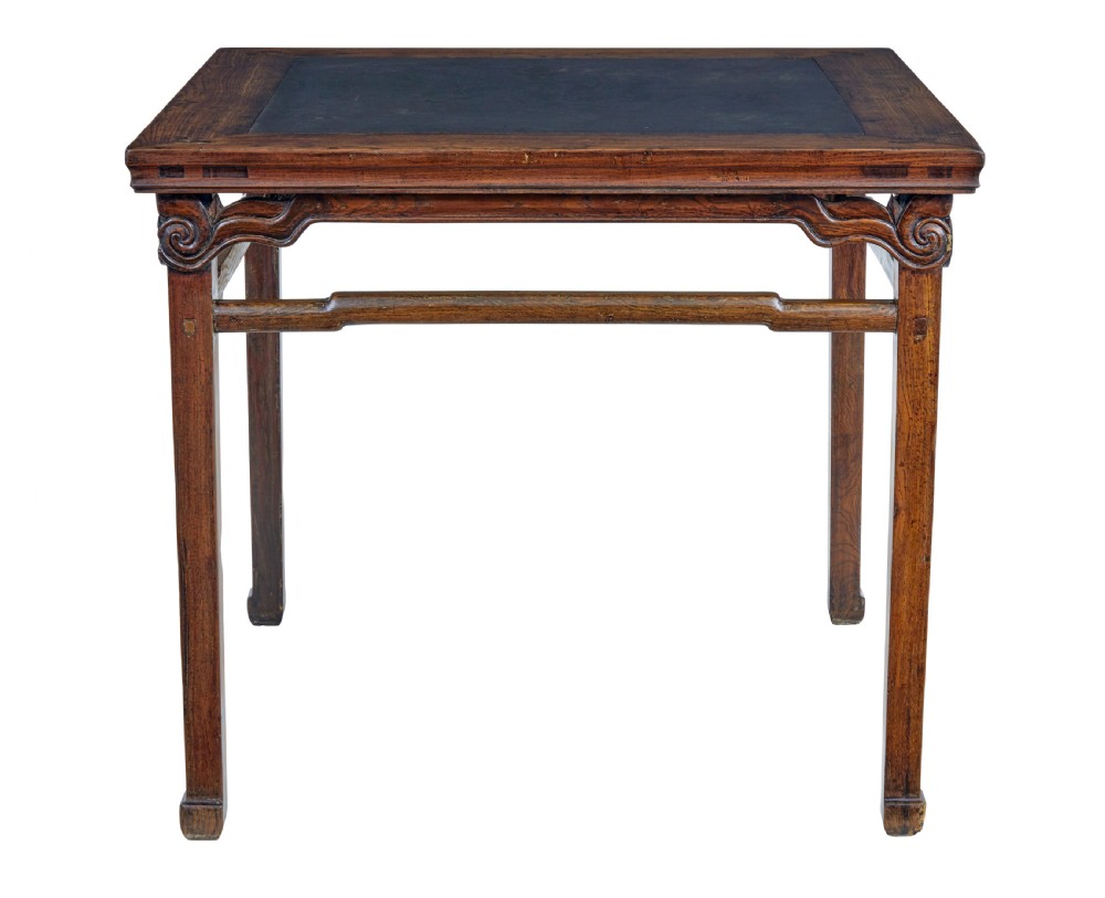 A 19th-century square Chinese hardwood centre table with an inset dark marble top, carved scroll spandrels, and humpback stretchers. View VI