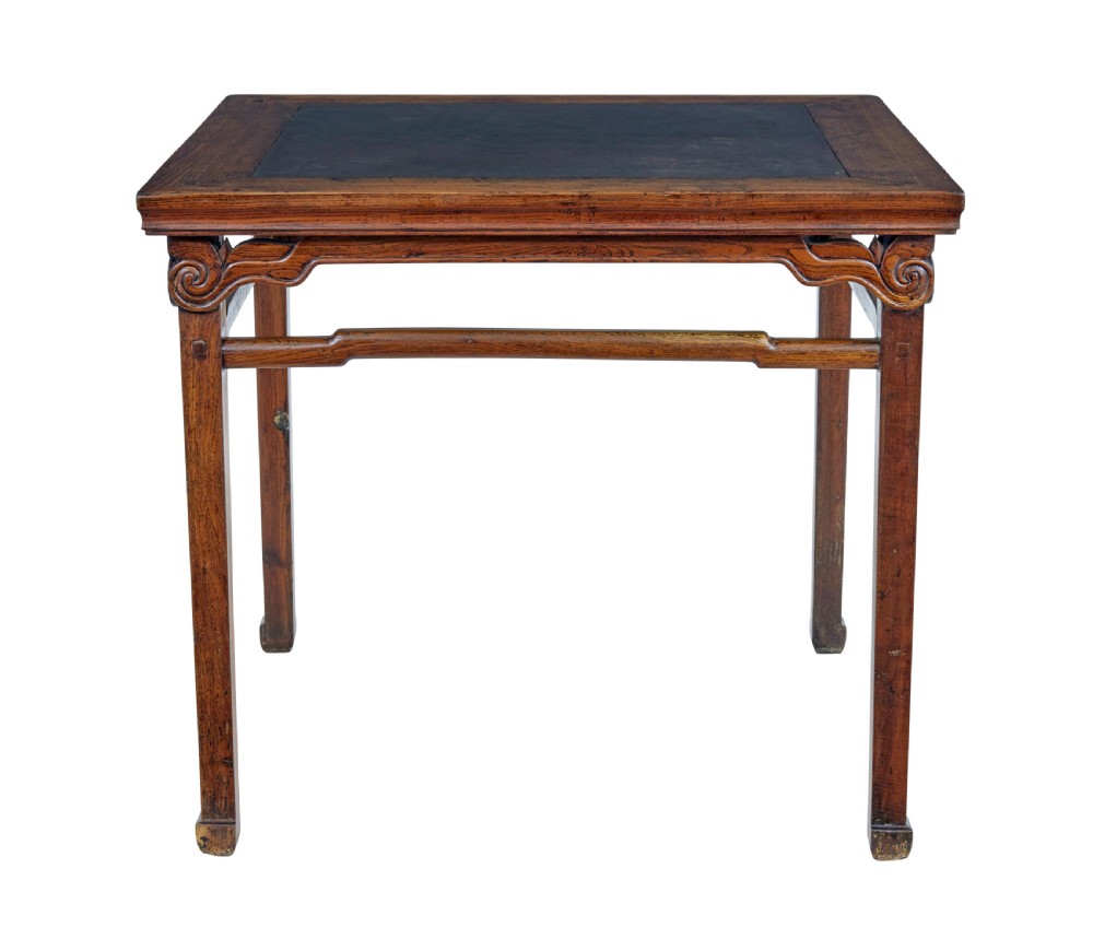 A 19th-century square Chinese hardwood centre table with an inset dark marble top, carved scroll spandrels, and humpback stretchers. View VII