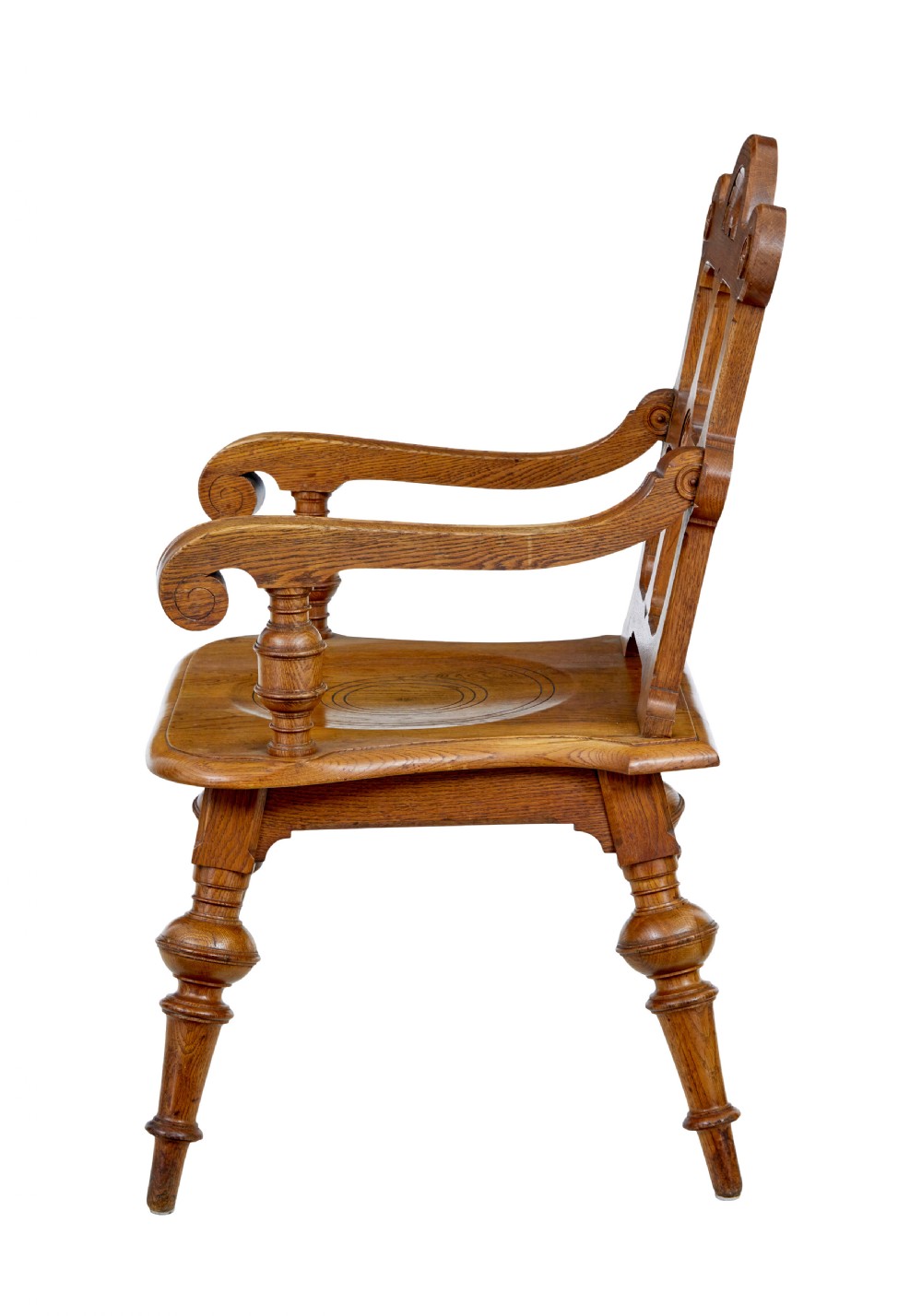 A late 19th-century carved oak armchair featuring a geometric openwork backrest with roundel details, turned legs, and sweeping wooden armrests. View VI