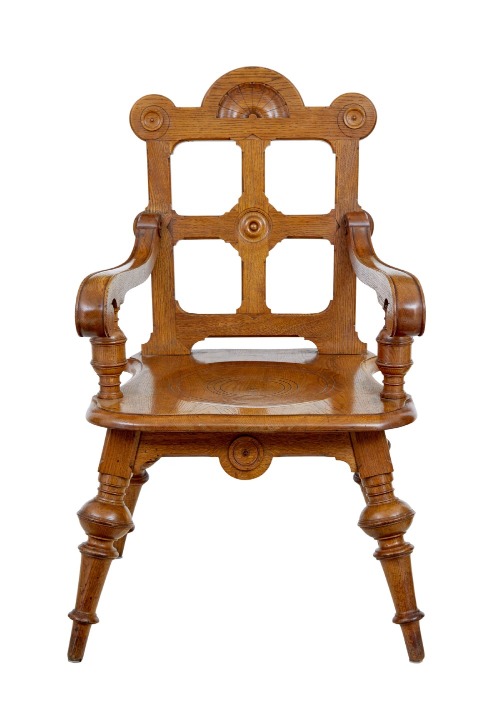 A late 19th-century carved oak armchair featuring a geometric openwork backrest with roundel details, turned legs, and sweeping wooden armrests. View VII