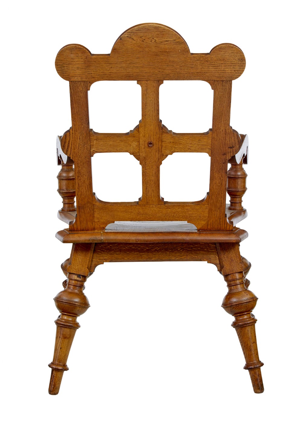 A late 19th-century carved oak armchair featuring a geometric openwork backrest with roundel details, turned legs, and sweeping wooden armrests. View IX