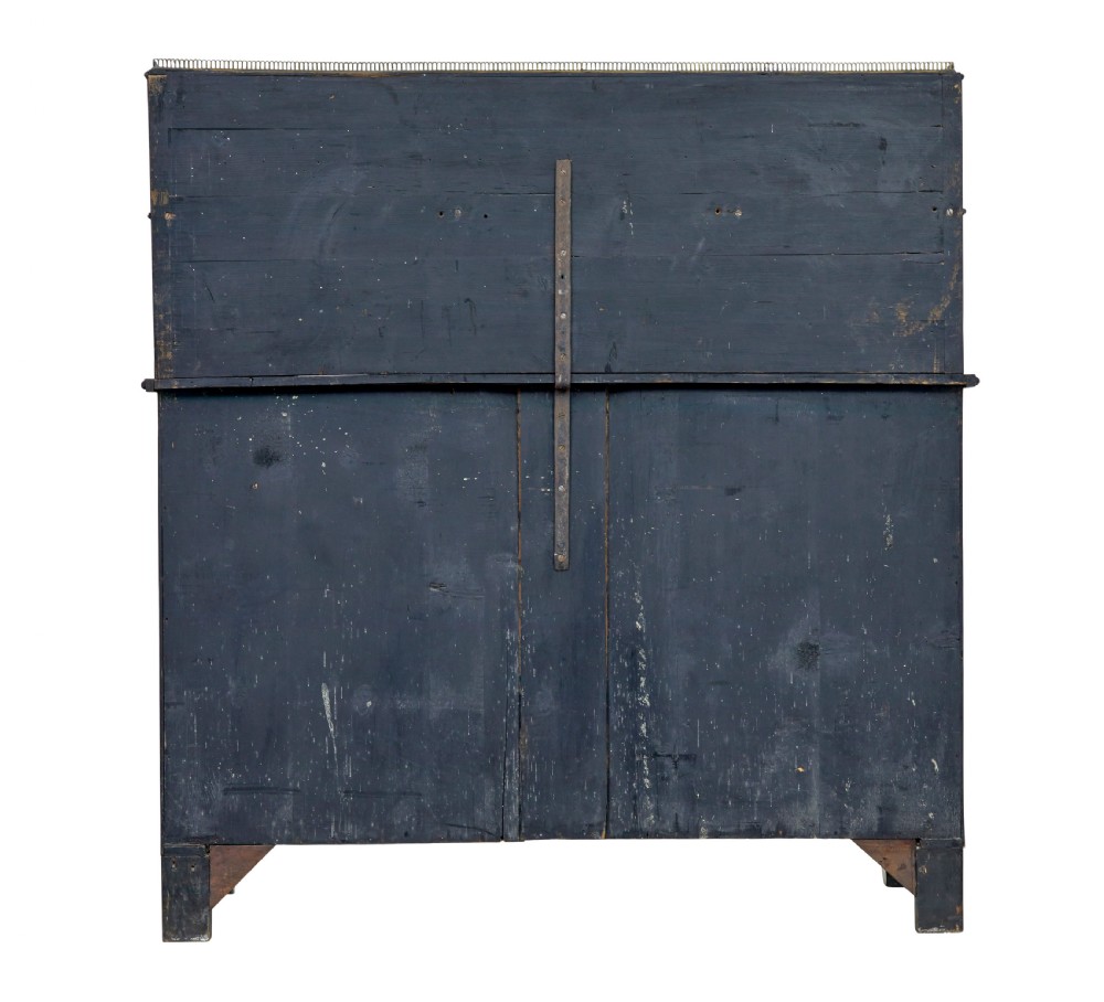 A 19th-century Regency palisander chiffonier with brass inlay, a two-tier raised shelf back supported by brass columns, and green pleated fabric door panels. View VI