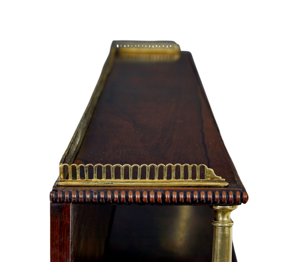 A 19th-century Regency palisander chiffonier with brass inlay, a two-tier raised shelf back supported by brass columns, and green pleated fabric door panels. View VIII