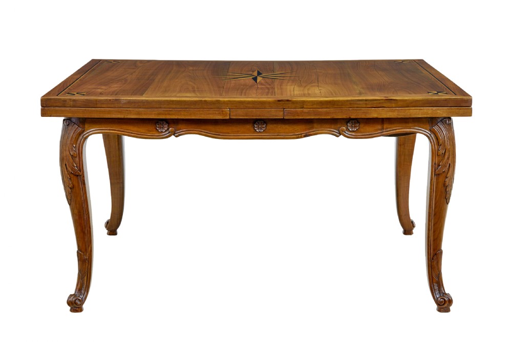 A 19th-century French fruitwood extending dining table with carved cabriole legs and a star inlay motif on the rectangular top. View II