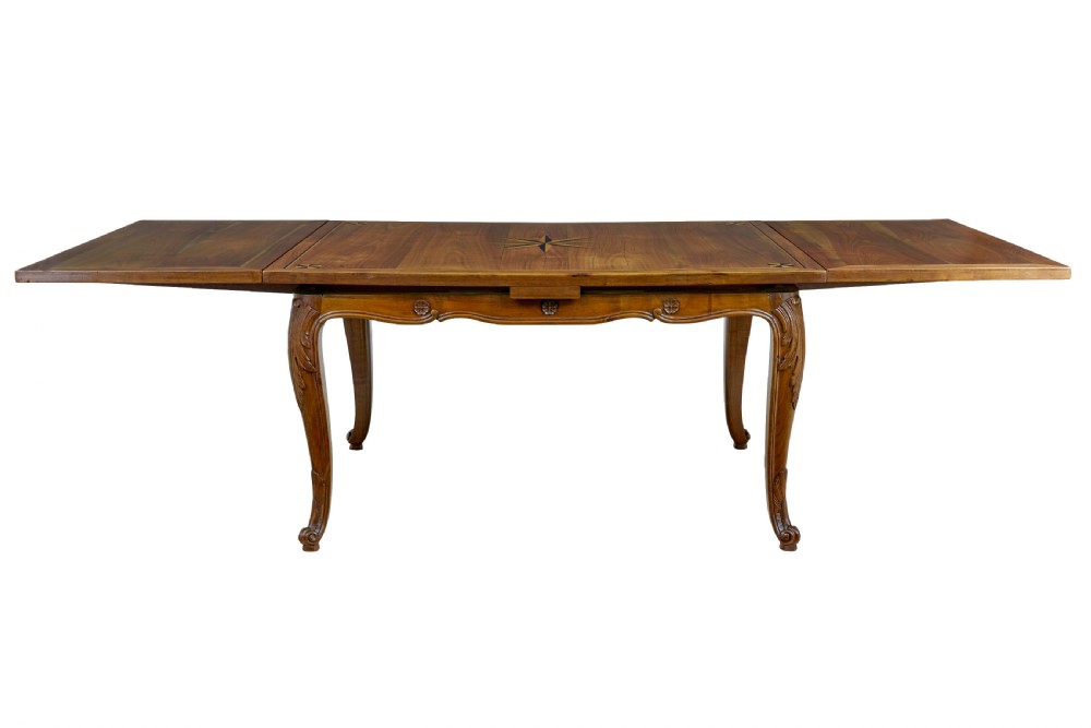 A 19th-century French fruitwood extending dining table with carved cabriole legs and a star inlay motif on the rectangular top. View IV