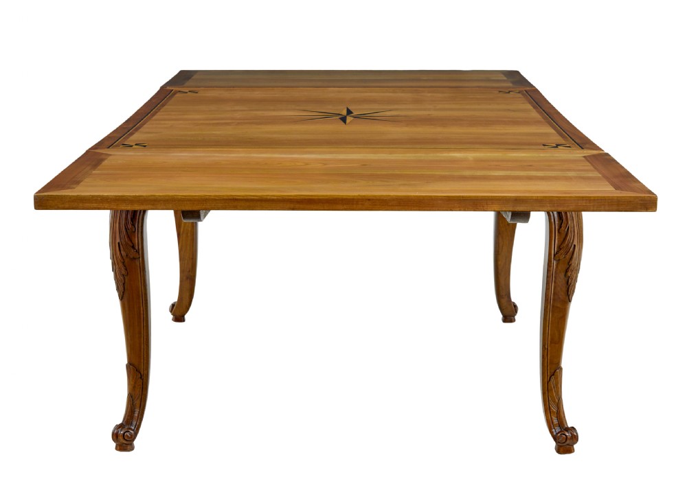 A 19th-century French fruitwood extending dining table with carved cabriole legs and a star inlay motif on the rectangular top. View V