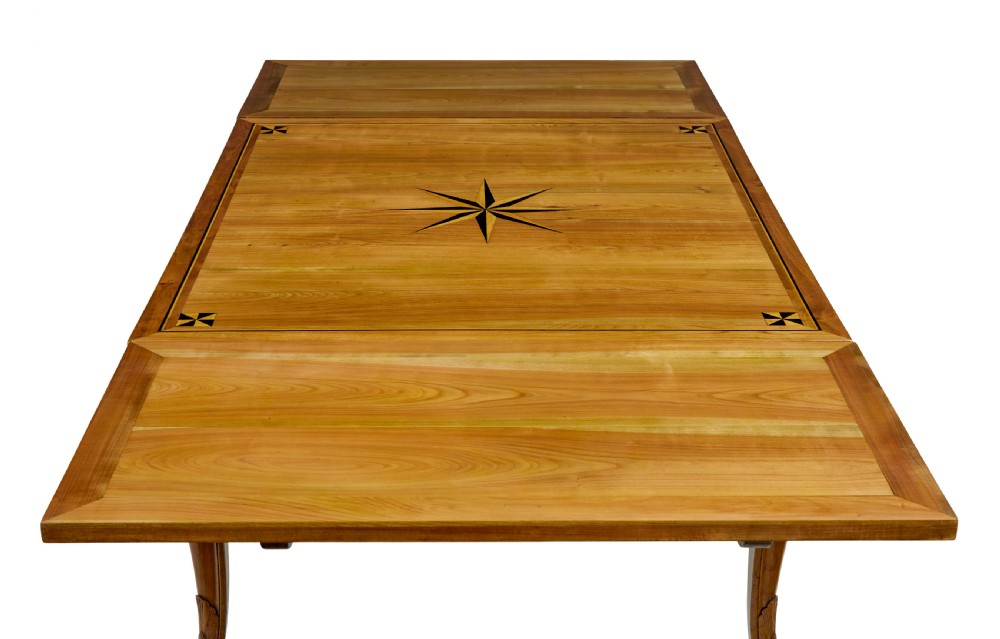 A 19th-century French fruitwood extending dining table with carved cabriole legs and a star inlay motif on the rectangular top. View VI