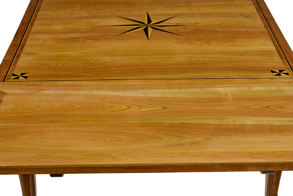 A 19th-century French fruitwood extending dining table with carved cabriole legs and a star inlay motif on the rectangular top. View VII