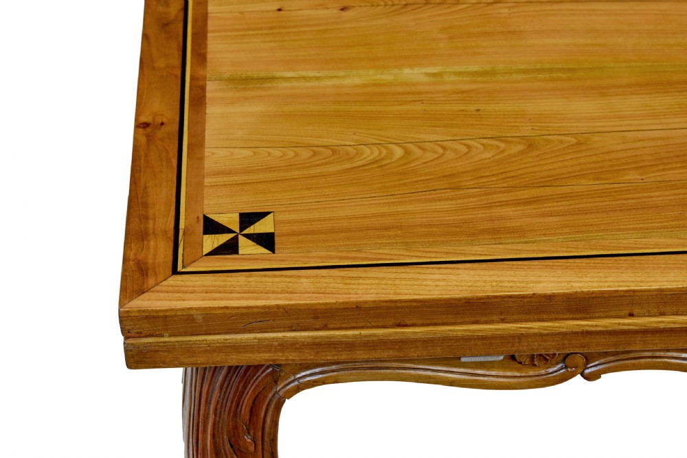 A 19th-century French fruitwood extending dining table with carved cabriole legs and a star inlay motif on the rectangular top. View IX