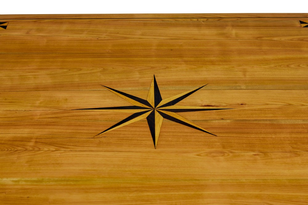 A 19th-century French fruitwood extending dining table with carved cabriole legs and a star inlay motif on the rectangular top. View X