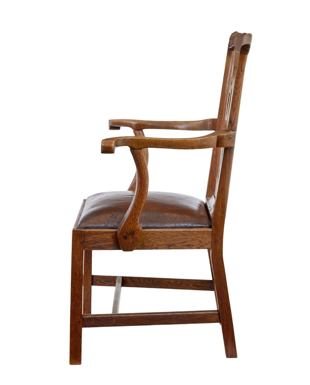 A 19th-century solid oak armchair featuring shepherds crook armrests, a carved pierced back splat, and a brown leather seat cushion. View III