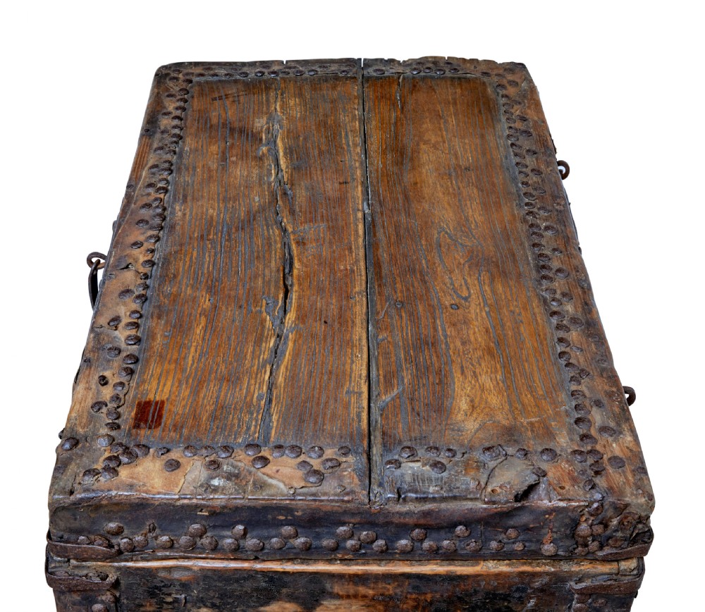 A dark brown 18th-century Chinese hardwood coffer chest with iron studding, metal corner bindings, a central latch, and side drop-handles. View VI
