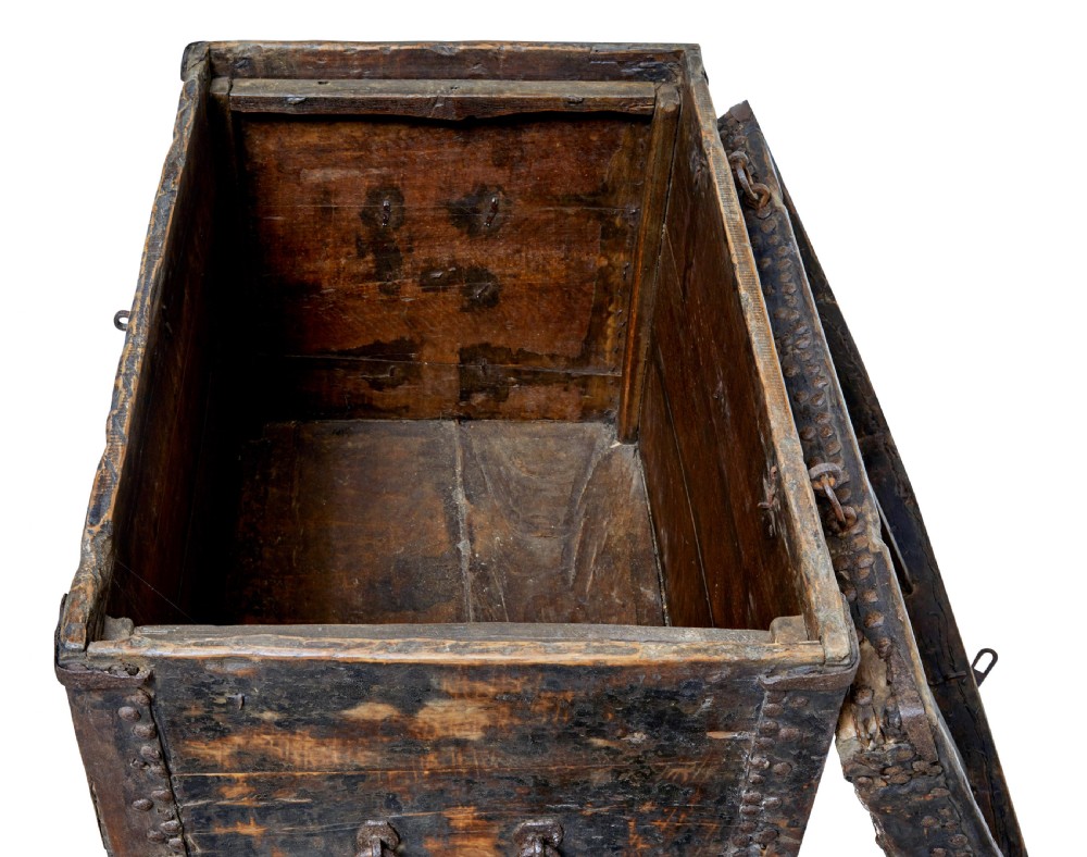 A dark brown 18th-century Chinese hardwood coffer chest with iron studding, metal corner bindings, a central latch, and side drop-handles. View VII