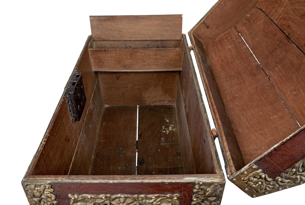 An 18th-century Danish dark oak dome-top coffer featuring intricate embossed brass straps, dual lock plates, and heavy side carrying handles. View VII