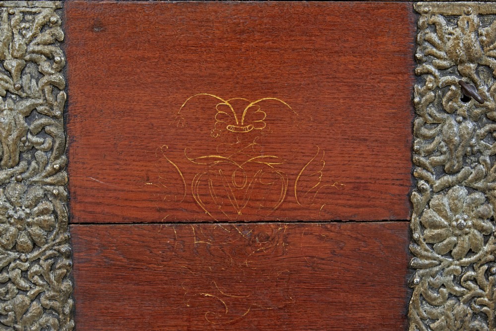 An 18th-century Danish dark oak dome-top coffer featuring intricate embossed brass straps, dual lock plates, and heavy side carrying handles. View VIII