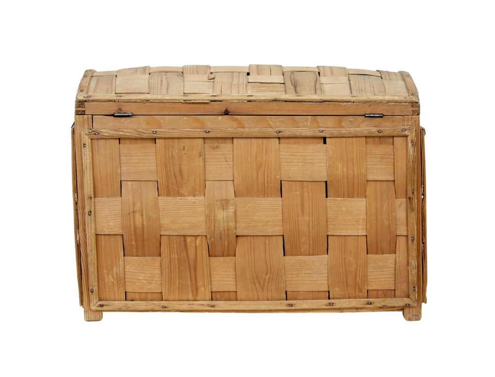 A late nineteenth-century Scandinavian trunk featuring woven pine strip construction, a domed lid, and iron side handles. View V