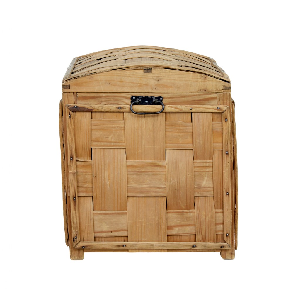 A late nineteenth-century Scandinavian trunk featuring woven pine strip construction, a domed lid, and iron side handles. View VI