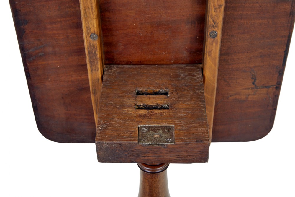 An early 19th-century mahogany tilt-top occasional table featuring a rectangular top, turned baluster stem, and three splayed legs. View V
